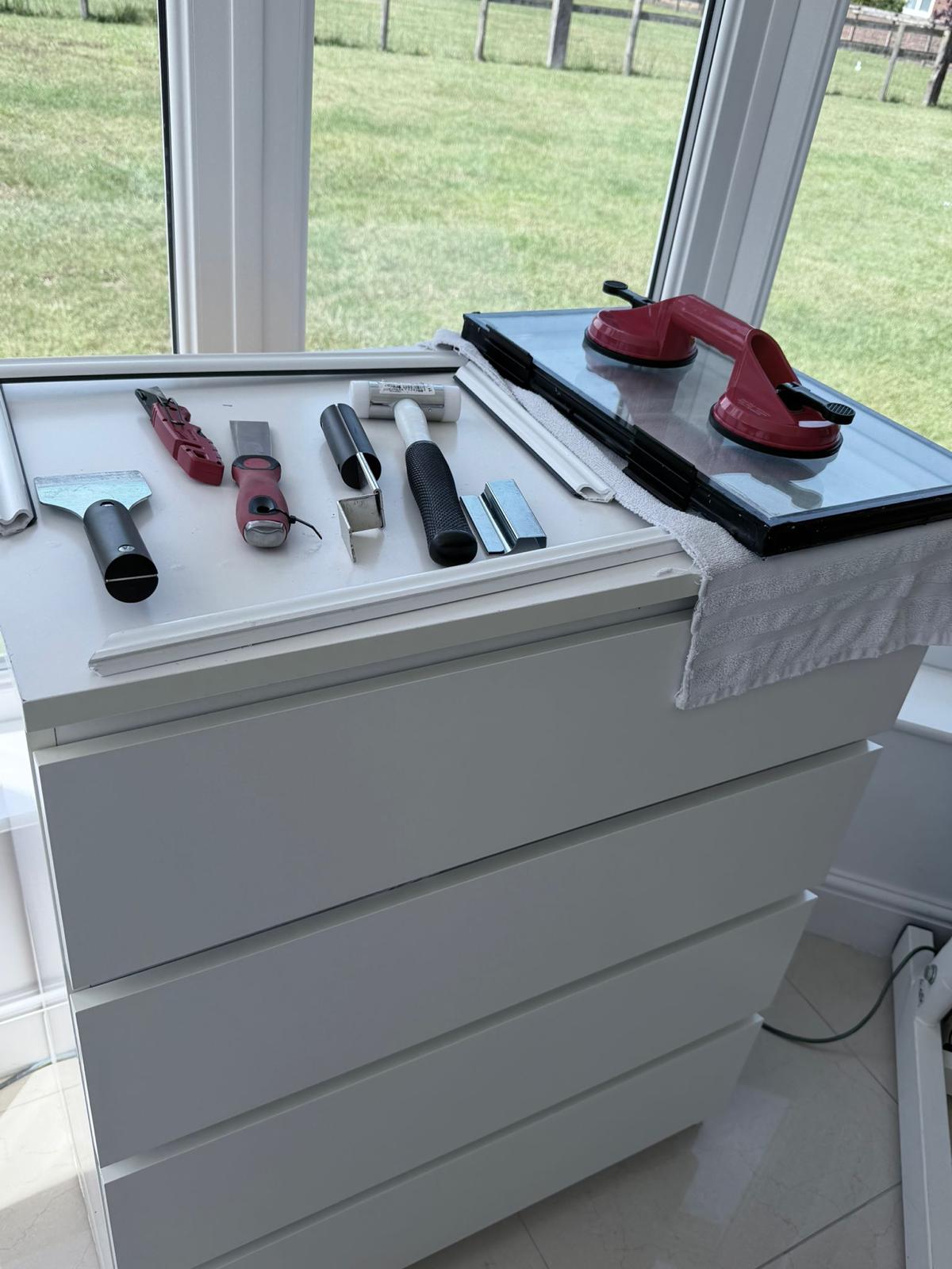 Glazing tools set out ready for a glass unit replacement